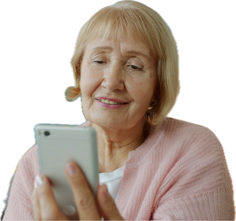 An older woman smiling at a text message on her phone